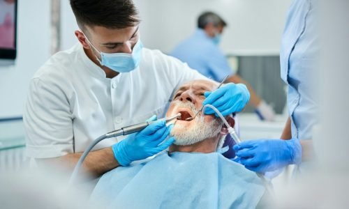 senior-man-having-teeth-polish-procedure-during-appointment-with-dentist-at-clinic-.jpg